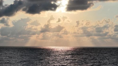 Vast ocean meets the horizon under a sunlit sky