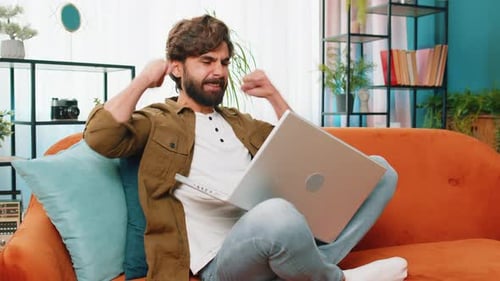 Young Man Working From Home on Laptop