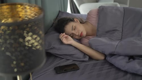 Woman Wakes Up to Phone Alarm in Bed