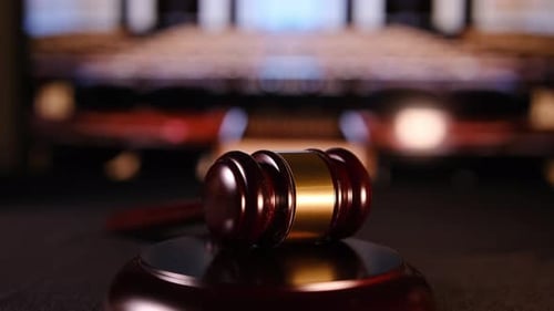A Closeup View of a Gavel Resting in a Courtroom Representing Justice Order and Legal Authority