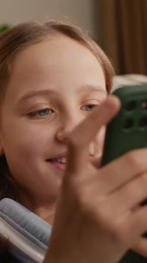 Blonde Girl Using Smartphone Device at Home