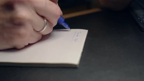 Person Writing a To-Do List on Notepad