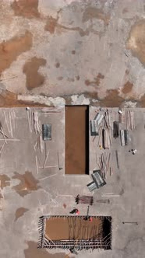 Vertical Video Early Stages of Construction Begin with Heavy Machines and Builders Working on