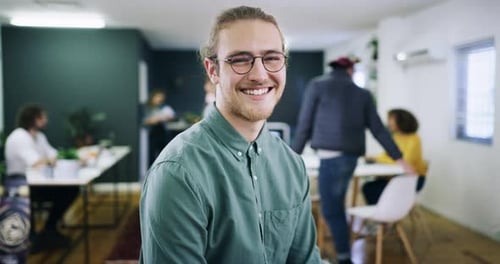 4k video footage of a handsome young businessman standing with his arms crossed in the office