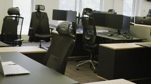 General view of modern office with desks and computers, slow motion