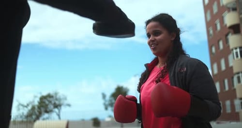 Woman Boxing in an Urban Setting During Daytime