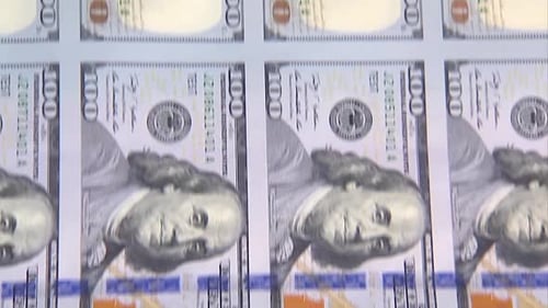 SHEET OF 100 DOLLAR BILLS AT THE PRINTING PRESS