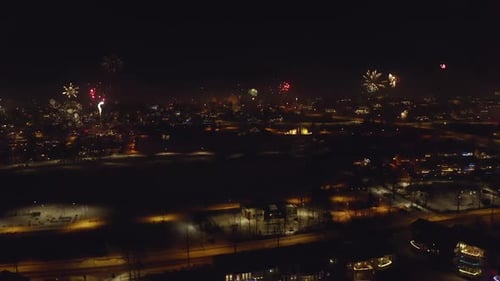 Fireworks Bursting Over Urban Landscape At Night. New Year's Eve Celebration In Iceland. aerial pann