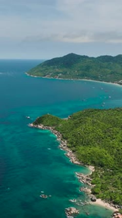 Tropical Coastline with Green Hills and Clear Blue Sea Koh Tao Thailand