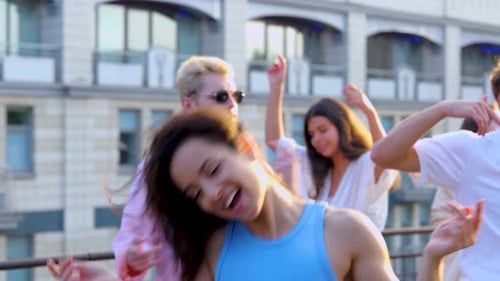 Friends Dancing on Rooftop in the Sunshine