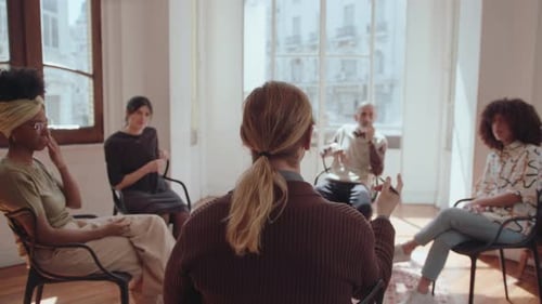 Adults in a Group Setting Chatting Indoors
