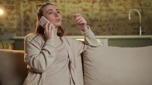 Woman Talking on Cell Phone on Couch