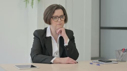 Woman in Business Pondering at Desk