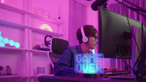 Young Adult Playing Video Game at Desk