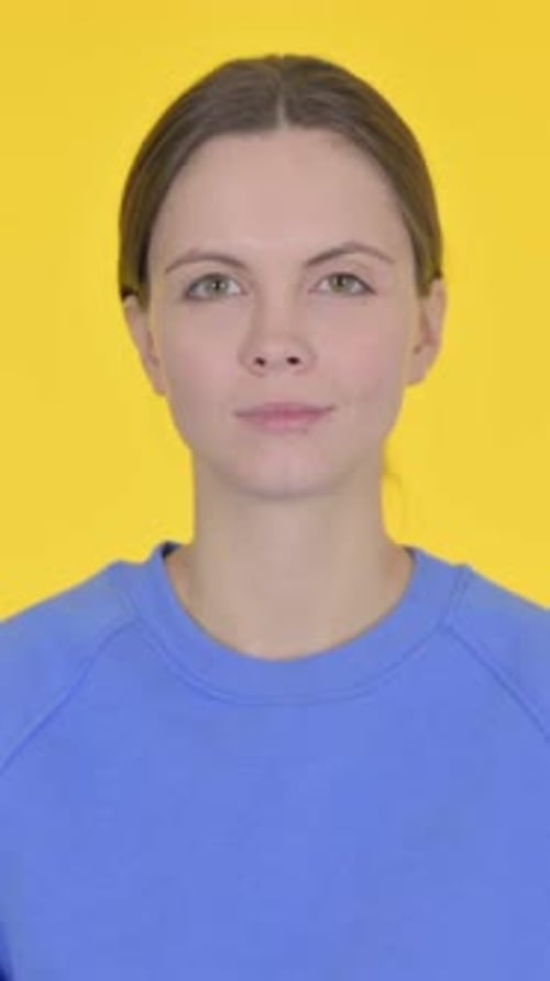 Young Woman Posing Against a Yellow Background