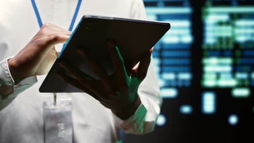 Man Works On Tablet with Data Screen Background
