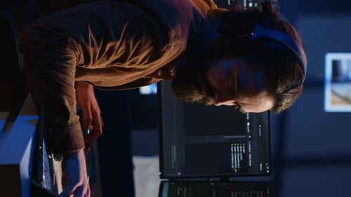 Programmer Taking Break From Coding Putting Headphones on and Stretching