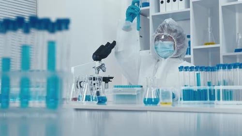 Scientist in Hazmat Suit Working with Test Tubes