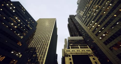 Tall Urban Buildings Rising Toward the Cloudy Sky at Dusk in the City