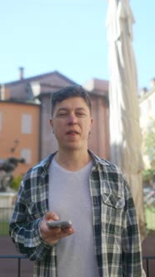 A Man Using a Smartphone in a City Demonstrating Modern Technology and Urban Lifestyle