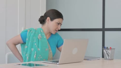 Woman Works at Laptop then Experiences Back Pain
