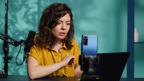 Woman Chatting with Subscribers Presenting Information on Notebook Device