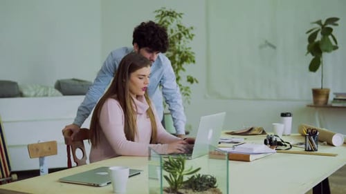Young Couple Working Together In An Office.