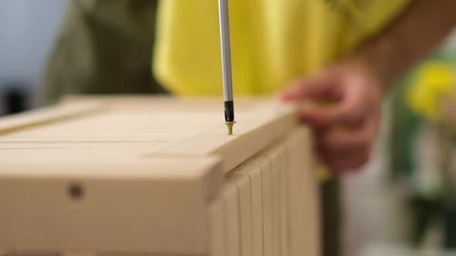 Furniture Assembly Using Hand Screwdriver for DIY Project