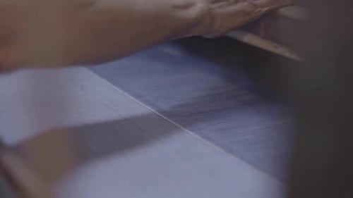 Hand Operating a Weaving Machine Close Up