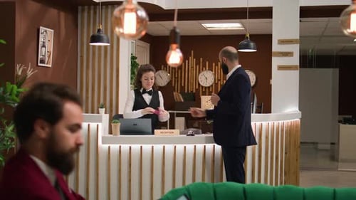 Man Checks into Modern Hotel Reception