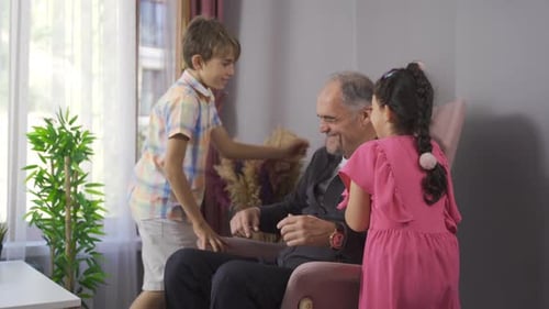 Grandfather Enjoying Loving Embrace from Grandchildren Indoors