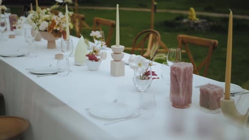 Elegant Wedding Reception Table Setting with Candles and Flowers
