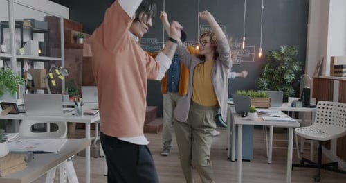 Multiethnic Group of Businesspeople Colleagues Dancing Enjoying Corporate Party in Office