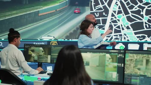 Diverse Team of Agency Employees Following Delivery Trucks Via Gps Coordinates