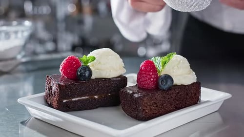 Chef Sprinkles Sugar on Brownie with Ice Cream