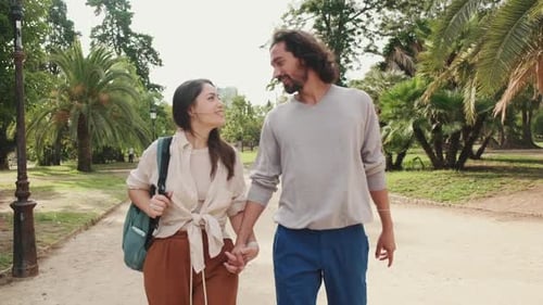 Couple in love walking in the park holding hands