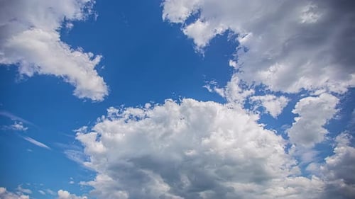 Fluffy White Clouds Drifting in a Blue Sky