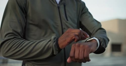 Hands, watch for fitness and a sports man outdoor in the city closeup for a marathon