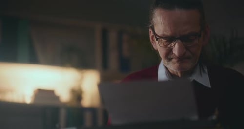 Man Typing on Typewriter Indoors
