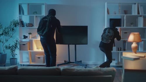 Two Masked People Search Dark Living Room