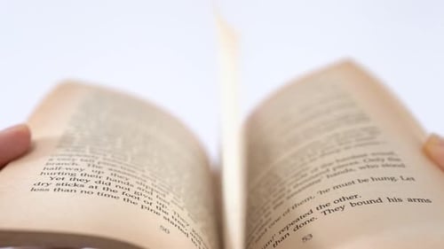 Hands Turn Pages of a Book Close Up