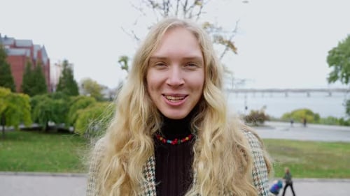 Blonde Haired Person Talking in City Park