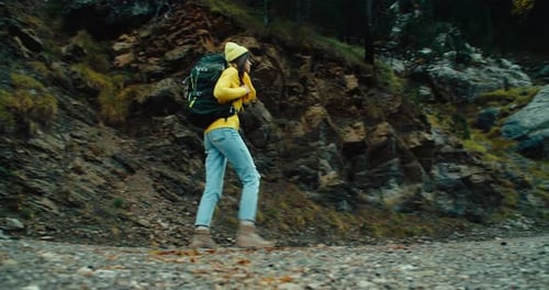 Woman on Vacation Trip Adventure Walk with Hike Backpack on Mountain Gravel Road