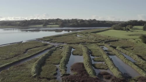 Aerial flight over flooded man-made mounds on river at Waterford, IRL