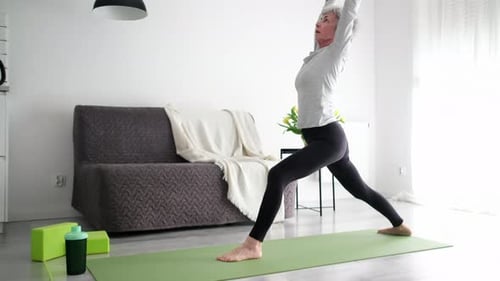 Senior Woman Practicing Yoga at Home