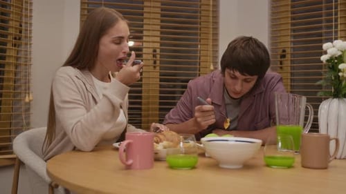 Two People Eating Dinner Together at Home
