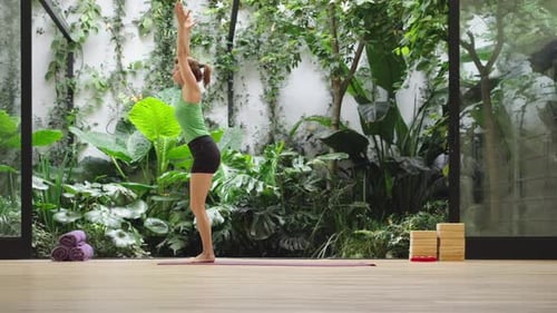 Woman Doing Yoga Exercise in Bright Indoor Studio