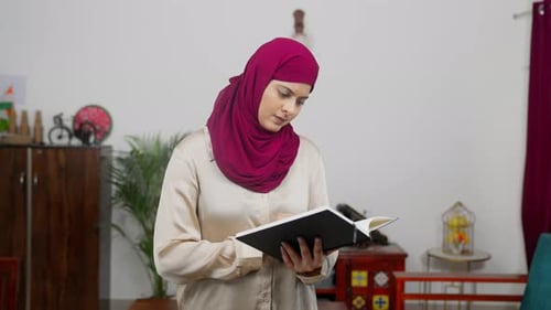 Muslim Woman in Hijab Scarf Reading book