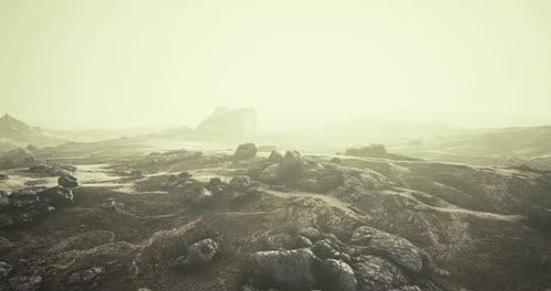 Mysterious Landscape with Mist Shrouding Rocky Terrain at Twilight