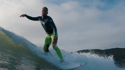 Surfer Rides the Wave in the Ocean